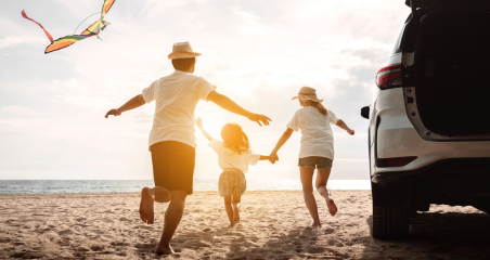 picture of a 3-person family at a beach