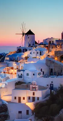picture of a white villa with a sunset of Santorini in Greece